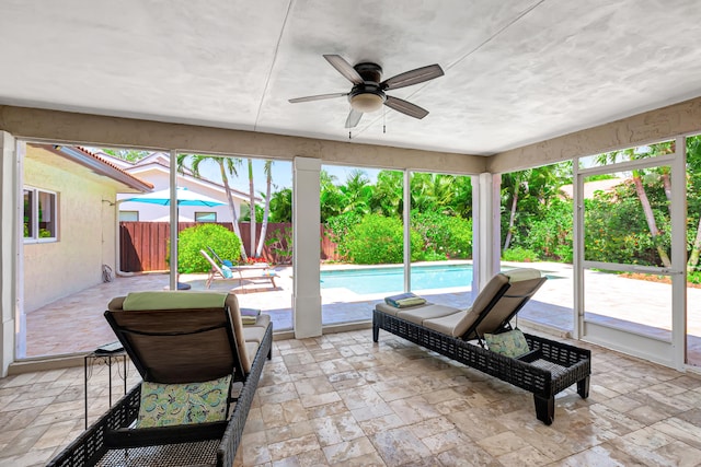 sunroom / solarium featuring ceiling fan