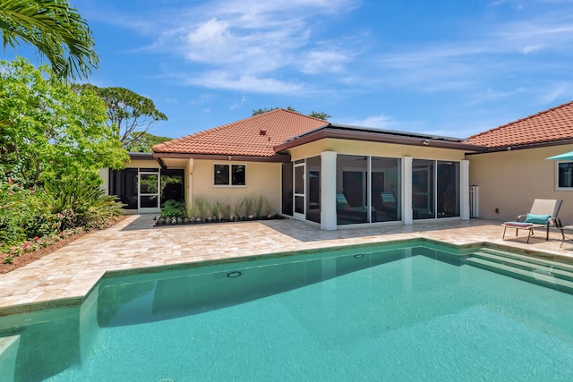 view of pool with a patio area and a sunroom