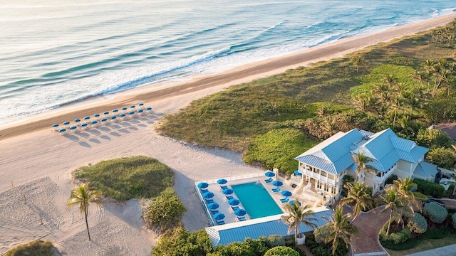 bird's eye view with a water view and a beach view