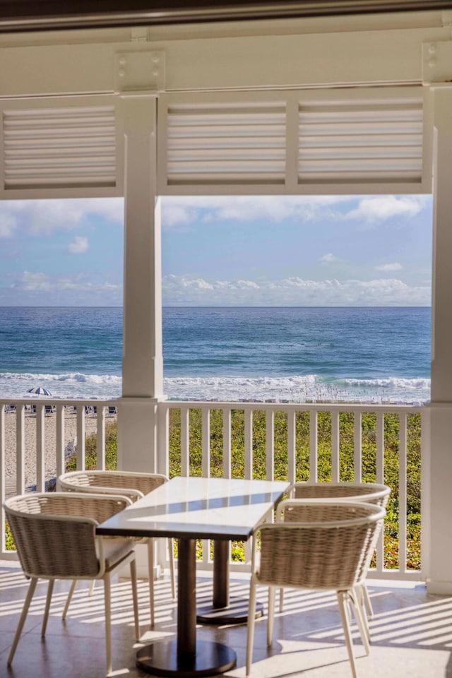 balcony with a beach view and a water view