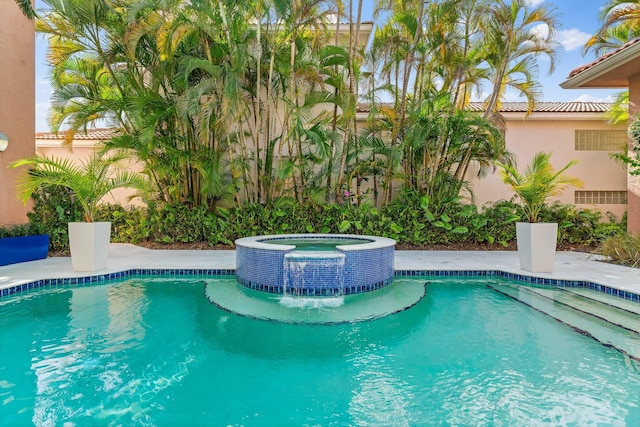 view of pool with a pool with connected hot tub