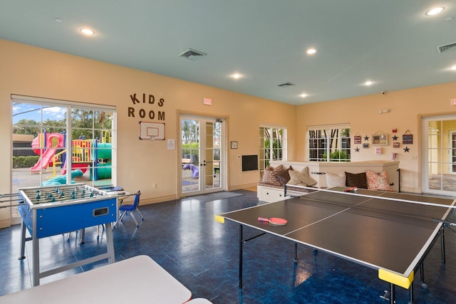 rec room featuring baseboards, plenty of natural light, and recessed lighting