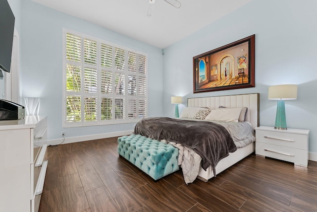 bedroom with dark wood-type flooring and baseboards