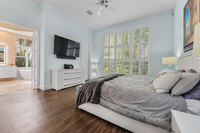 bedroom featuring visible vents, ensuite bathroom, a ceiling fan, wood finished floors, and baseboards