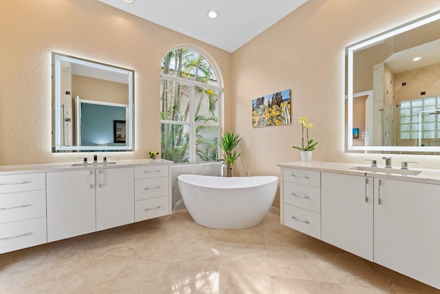 bathroom featuring shower with separate bathtub, vanity, and lofted ceiling