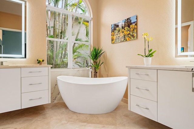 bathroom with vanity, a tub to relax in, and tile patterned floors