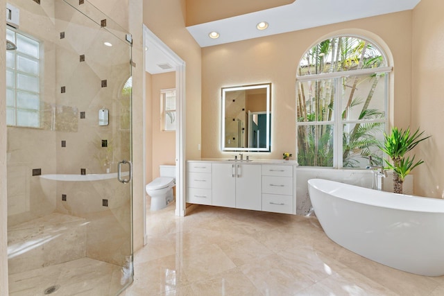 full bathroom featuring recessed lighting, a soaking tub, toilet, a stall shower, and vanity