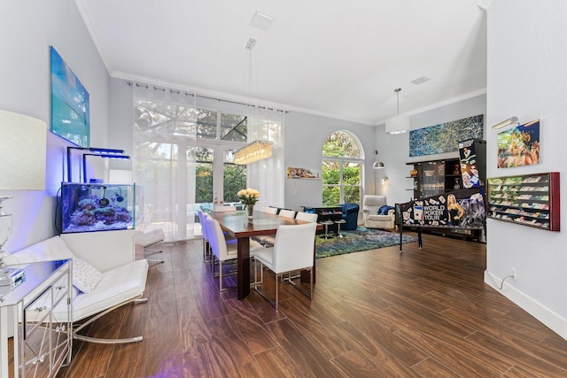 dining space with ornamental molding, visible vents, and wood finished floors