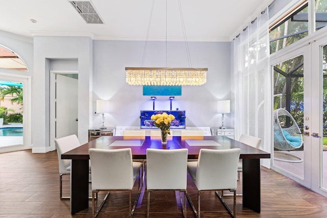 dining area featuring dark wood-style flooring, visible vents, crown molding, and french doors