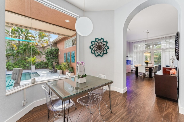 dining space with dark hardwood / wood-style flooring and vaulted ceiling