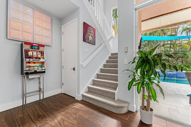 stairs featuring baseboards and wood finished floors