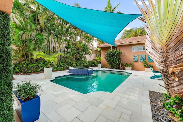 view of swimming pool with an in ground hot tub and a patio