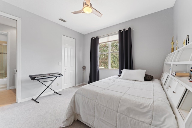 bedroom with a closet, light colored carpet, visible vents, a ceiling fan, and baseboards