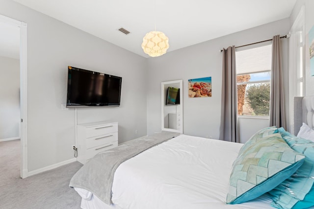 bedroom featuring light colored carpet, visible vents, and baseboards