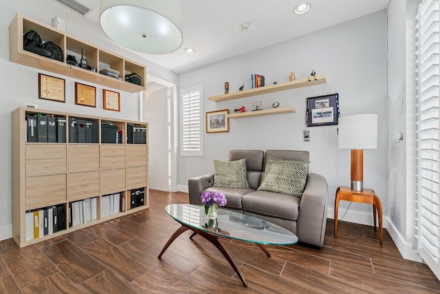 living room featuring wood tiled floor, visible vents, baseboards, and recessed lighting