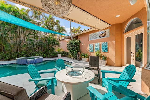 view of patio with french doors, an outdoor fire pit, and a pool with connected hot tub