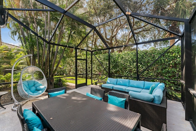 view of patio with glass enclosure and outdoor lounge area