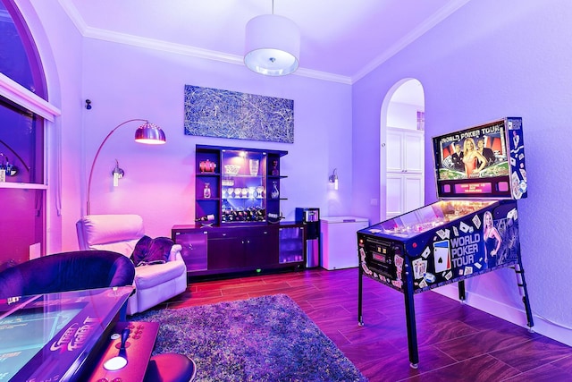 playroom featuring arched walkways, ornamental molding, and wood finished floors