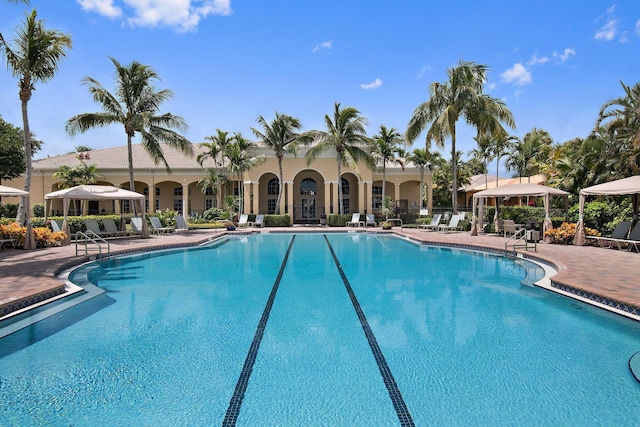 pool with a patio and a gazebo