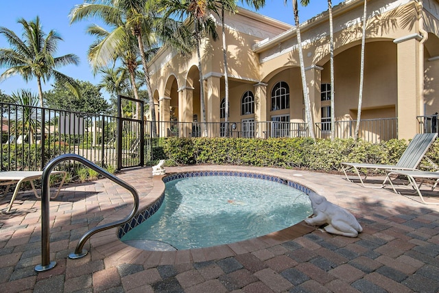 view of pool with a patio area, fence, and a pool