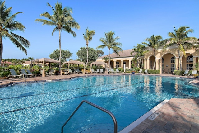 community pool with a patio and a gazebo