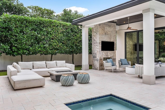 view of patio featuring an outdoor living space with a fireplace