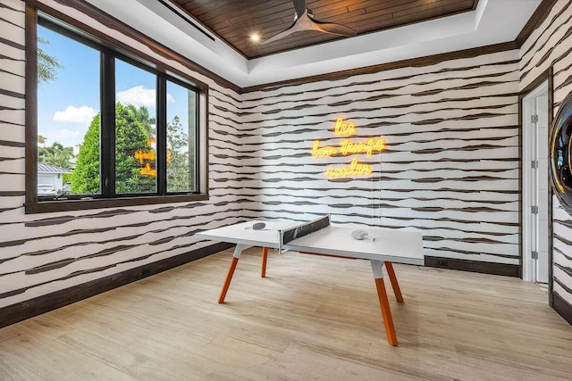 interior space featuring a raised ceiling, wooden ceiling, and light hardwood / wood-style floors