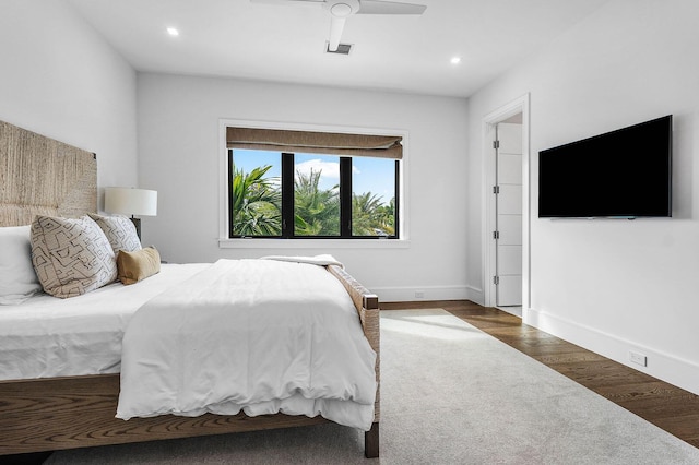 bedroom with ceiling fan and dark wood-type flooring