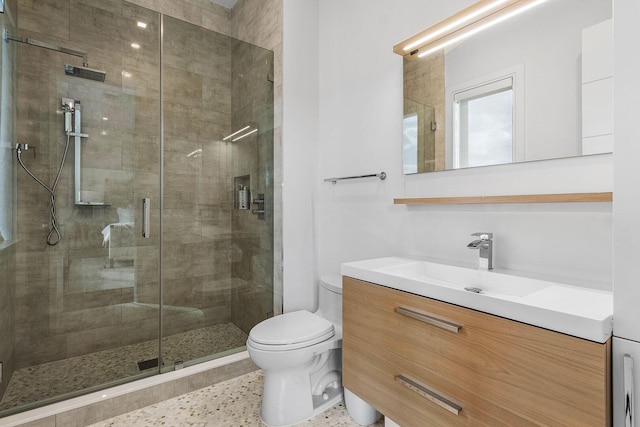 bathroom with vanity, an enclosed shower, and toilet