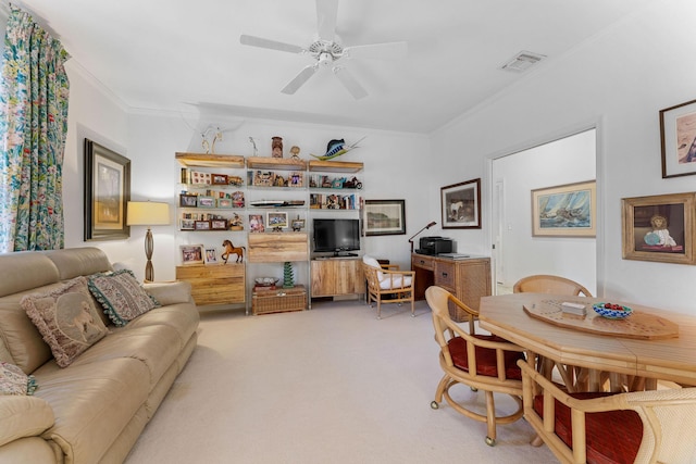 living room featuring crown molding, ceiling fan, and light carpet