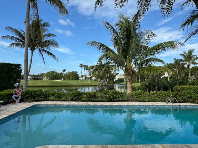 view of swimming pool featuring a water view