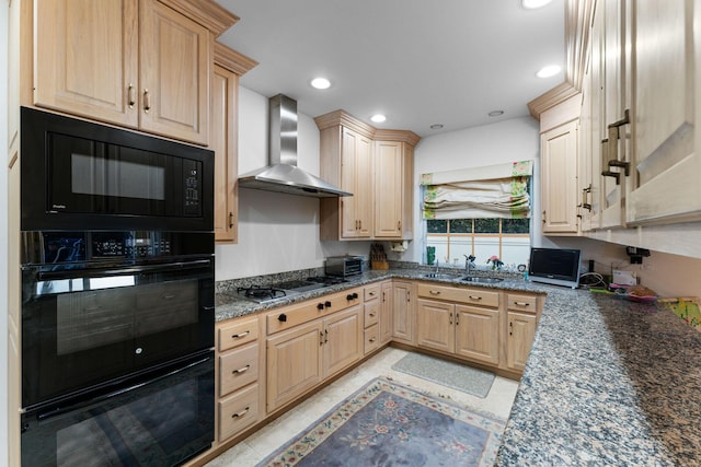 kitchen featuring light brown cabinetry, sink, dark stone counters, black appliances, and wall chimney exhaust hood