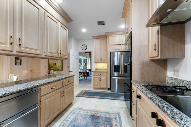 kitchen with light brown cabinetry, black appliances, and stone counters