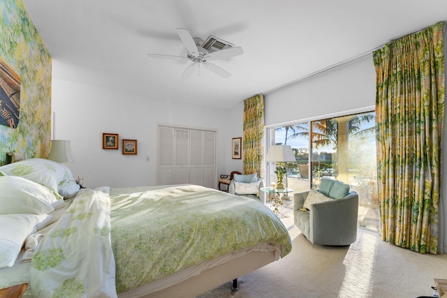 carpeted bedroom with access to exterior, ceiling fan, and a closet