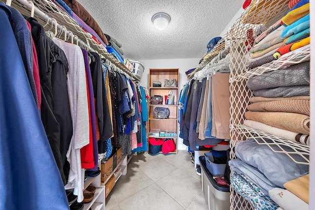 spacious closet with light tile patterned floors