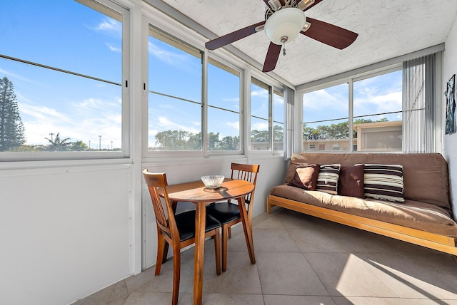 sunroom / solarium featuring ceiling fan