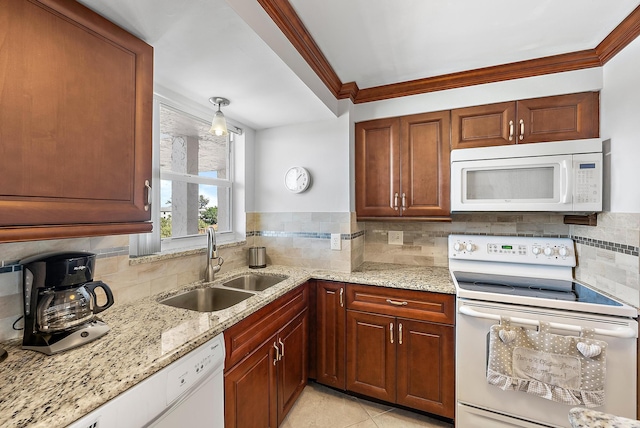 kitchen featuring light stone countertops, sink, backsplash, white appliances, and crown molding