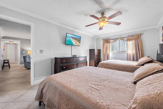 tiled bedroom with ceiling fan, ornamental molding, and a textured ceiling