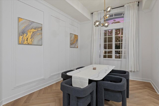 dining space with light parquet flooring and a notable chandelier