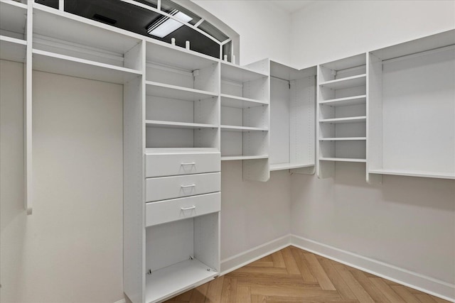 spacious closet with parquet flooring