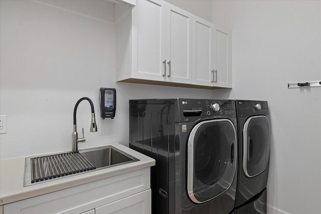 laundry area with cabinets, sink, and washing machine and clothes dryer