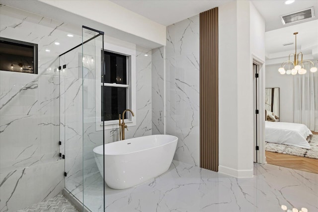 bathroom with independent shower and bath and an inviting chandelier