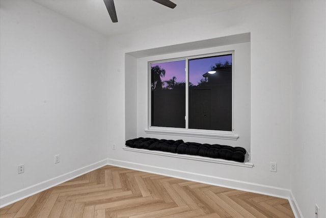 unfurnished room with ceiling fan and parquet floors