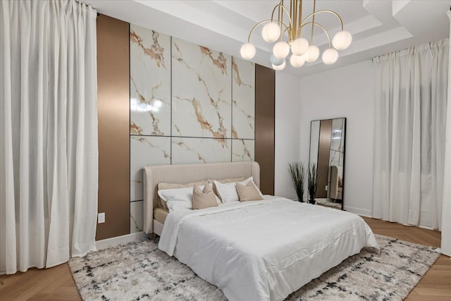 bedroom with light hardwood / wood-style flooring and a chandelier