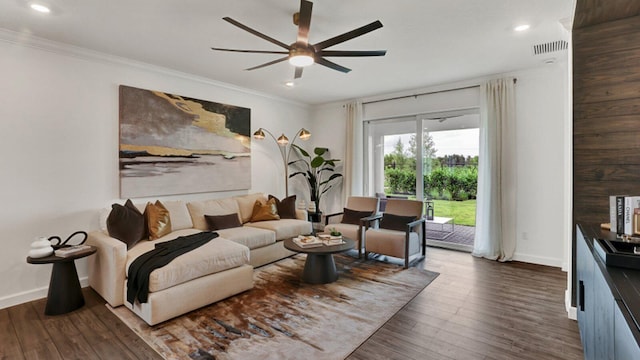 living room featuring dark hardwood / wood-style floors, ceiling fan, and ornamental molding