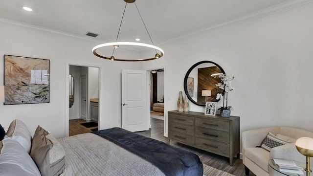 bedroom with dark hardwood / wood-style flooring and ornamental molding