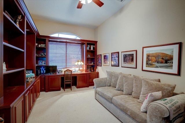 carpeted office space featuring vaulted ceiling and ceiling fan