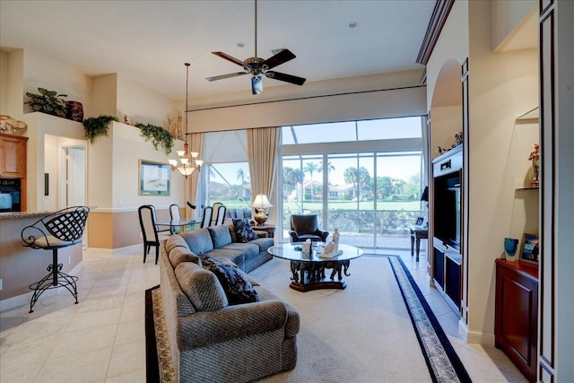 living room with light tile patterned floors and ceiling fan with notable chandelier