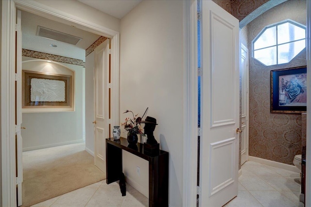 corridor featuring light tile patterned floors