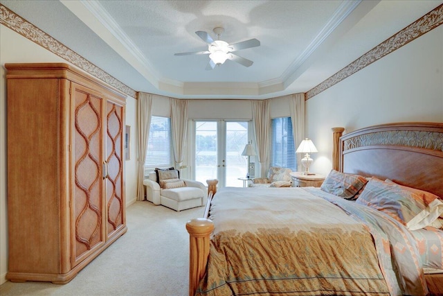 bedroom with carpet, access to outside, ceiling fan, ornamental molding, and a tray ceiling